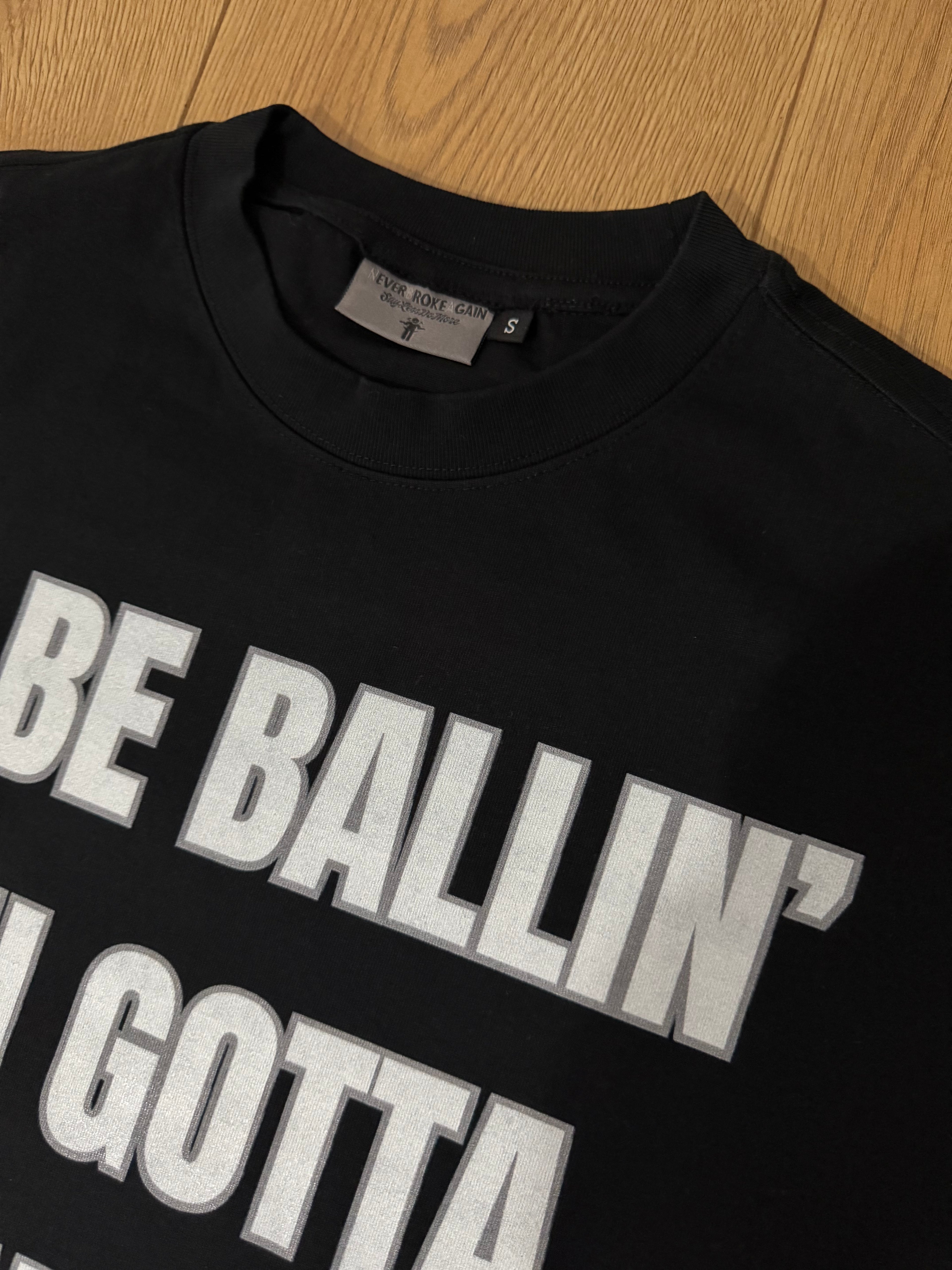 Black “ALL-IN” Tee by NBASayLessDoMore, front view showing casual fit and minimalist design.